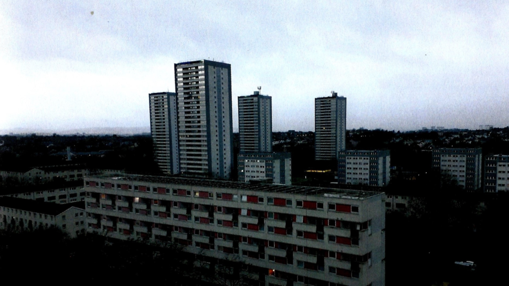 The buildings of Wyndford Estate, against a blue sky.