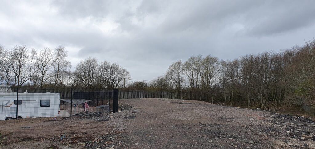 Construction refuse where a greenspace once was on a Gypsy/Traveller site by Cornell Hanxomphou